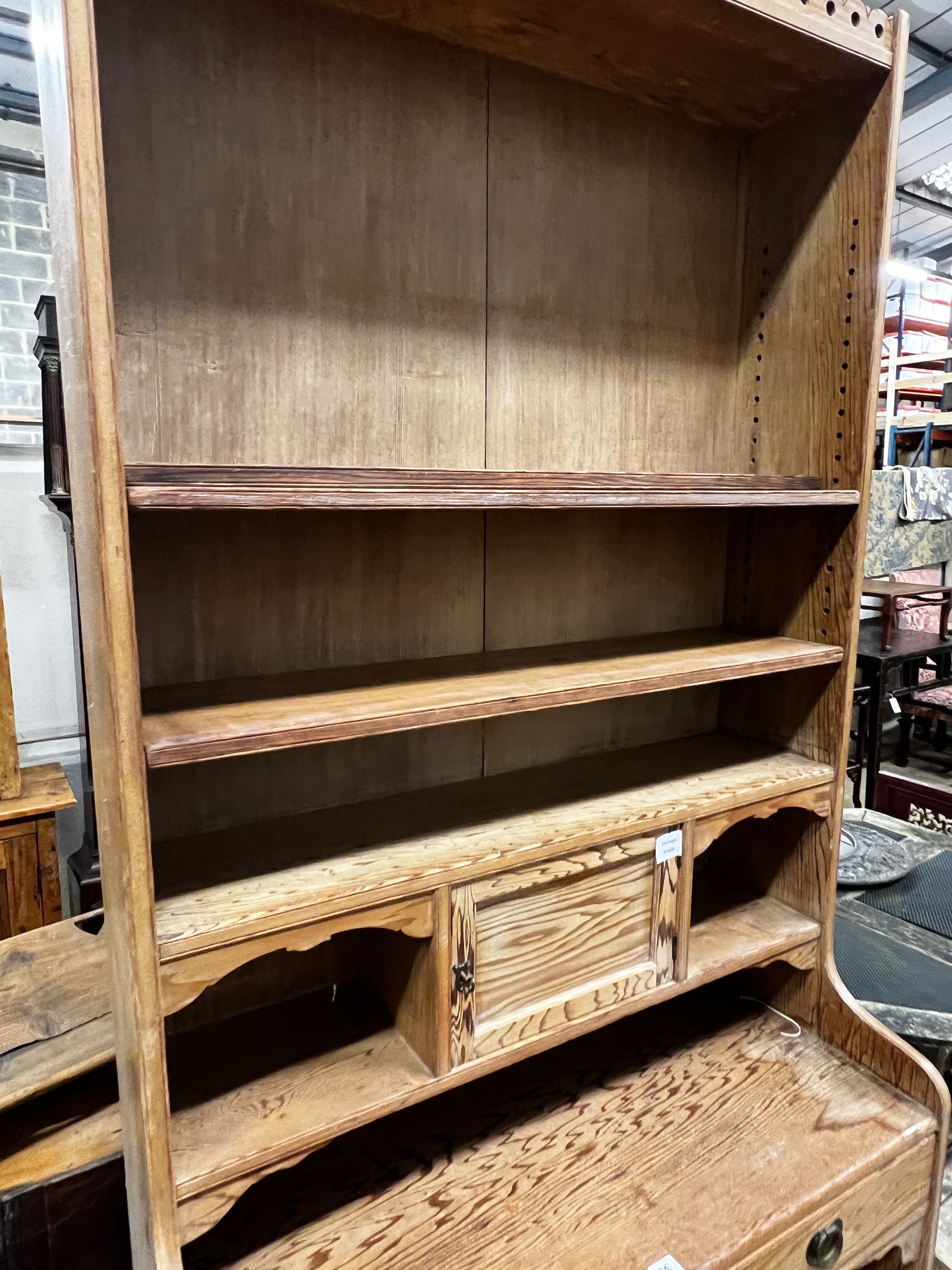 An Arts & Crafts pitch pine dresser with secretaire drawer, length 92cm, depth 41cm, height 220cm